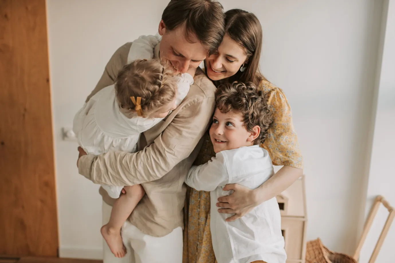 Happy family of four celebrating their growing family after a successful surrogacy journey.
