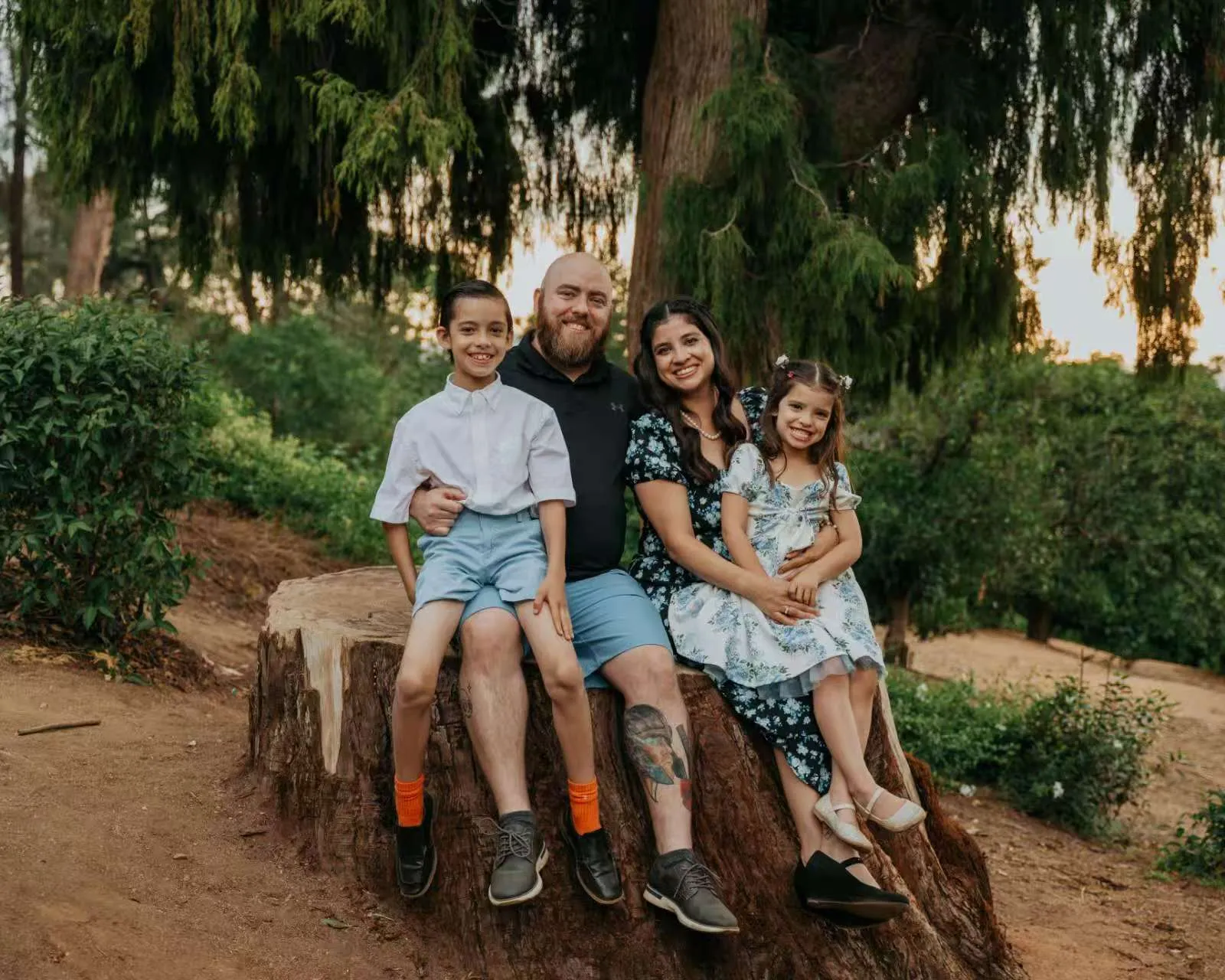 Happy family of four smiling together.
