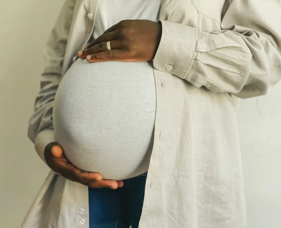 Pregnant woman holding her belly