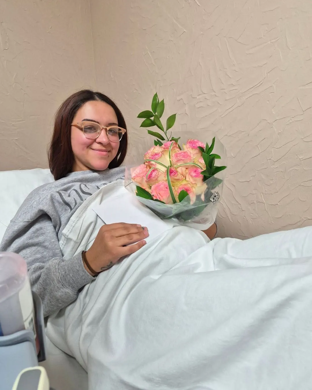 Smiling surrogate holding flowers outdoors in Los Angeles.