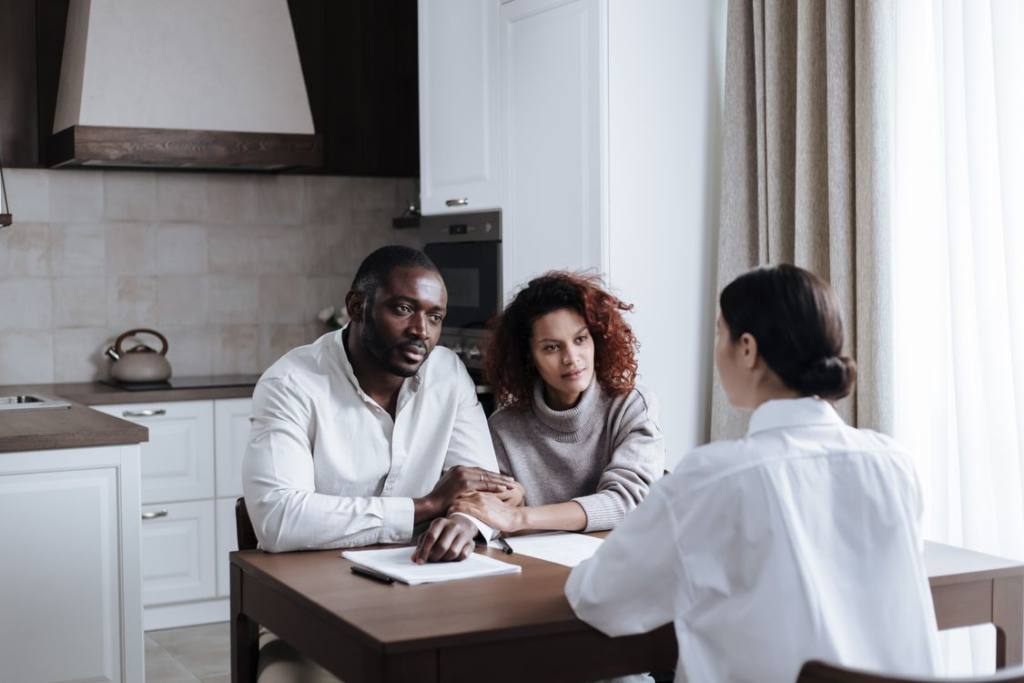 Intended parents meeting their gestational surrogate during a supportive agency meeting.