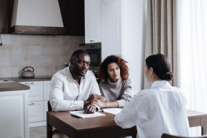 Intended parents meeting with a surrogacy coordinator to discuss their family-building journey